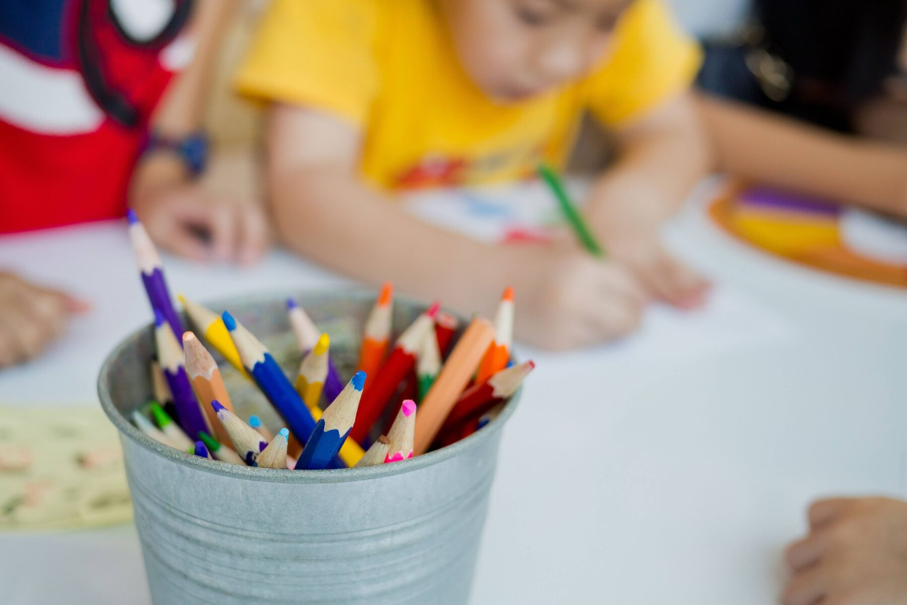 Children coloring at a table