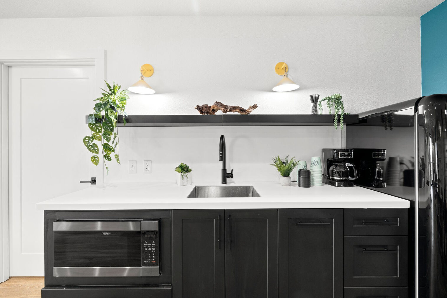 Kitchenette with fridge, microwave, and coffee pot