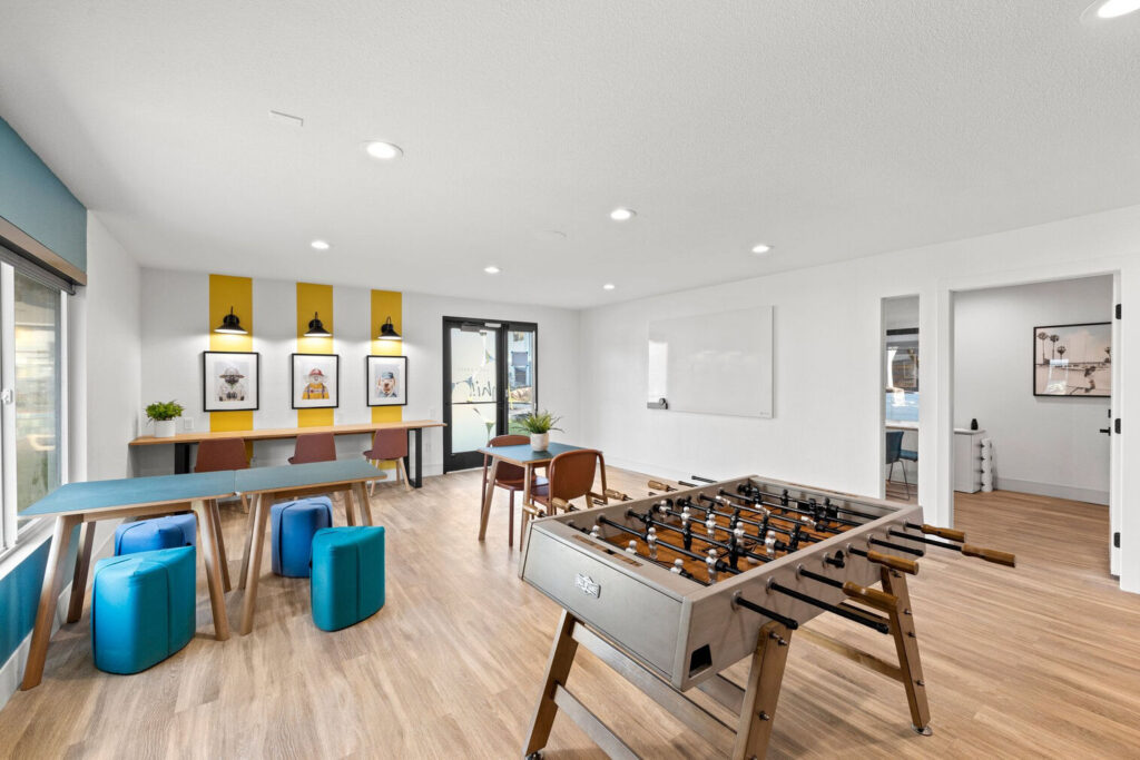 Kids club room with desks and chairs, books and board games