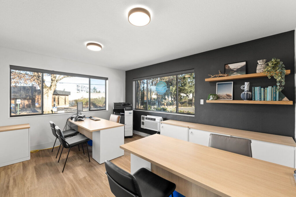 Leasing office reception desk with large windows at Lake Crest apartments in Clackamas County