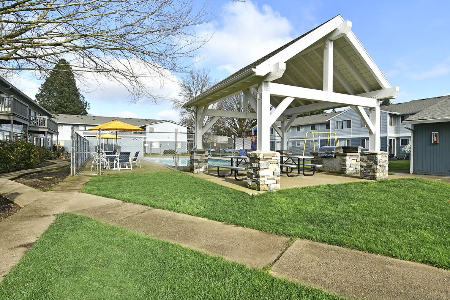 Outdoor area with fenced pool, Playground, and covered pavilion