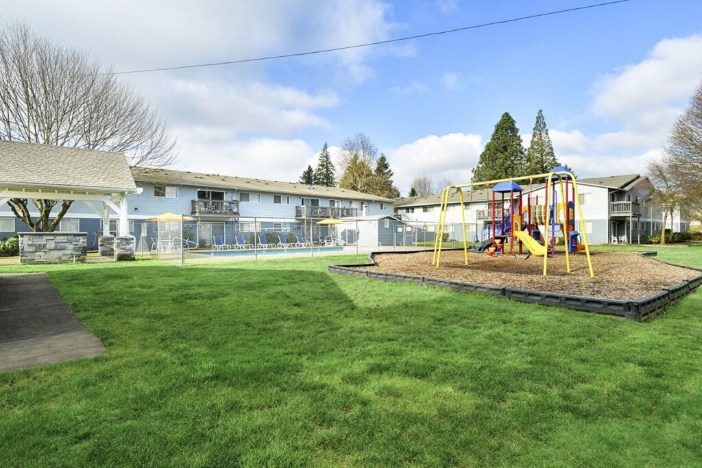 Outdoor area with fenced pool, Playground, and covered pavilion